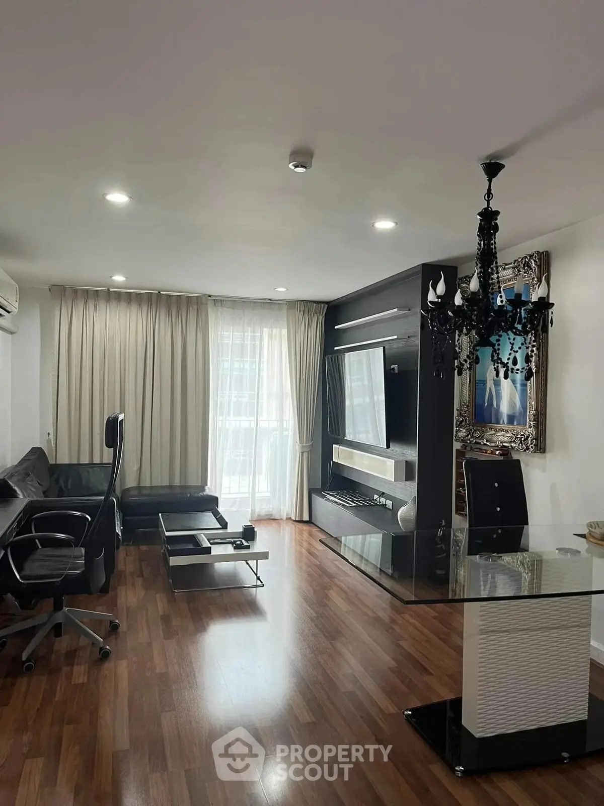 Modern living room with elegant chandelier and sleek furniture