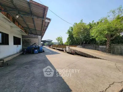 Spacious industrial property with ample outdoor space and greenery.