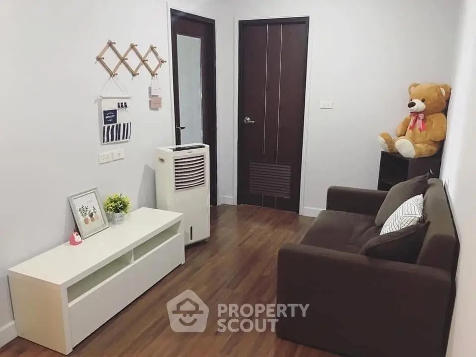 Cozy living room with brown sofa and teddy bear decor