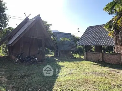 Charming rustic huts with sloped roofs in a serene natural setting, perfect for a tranquil retreat.