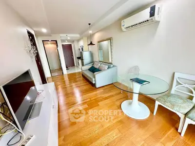 Modern living room with wooden flooring, stylish furniture, and air conditioning in a cozy apartment.