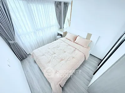 Bright and airy bedroom with modern decor and large windows.