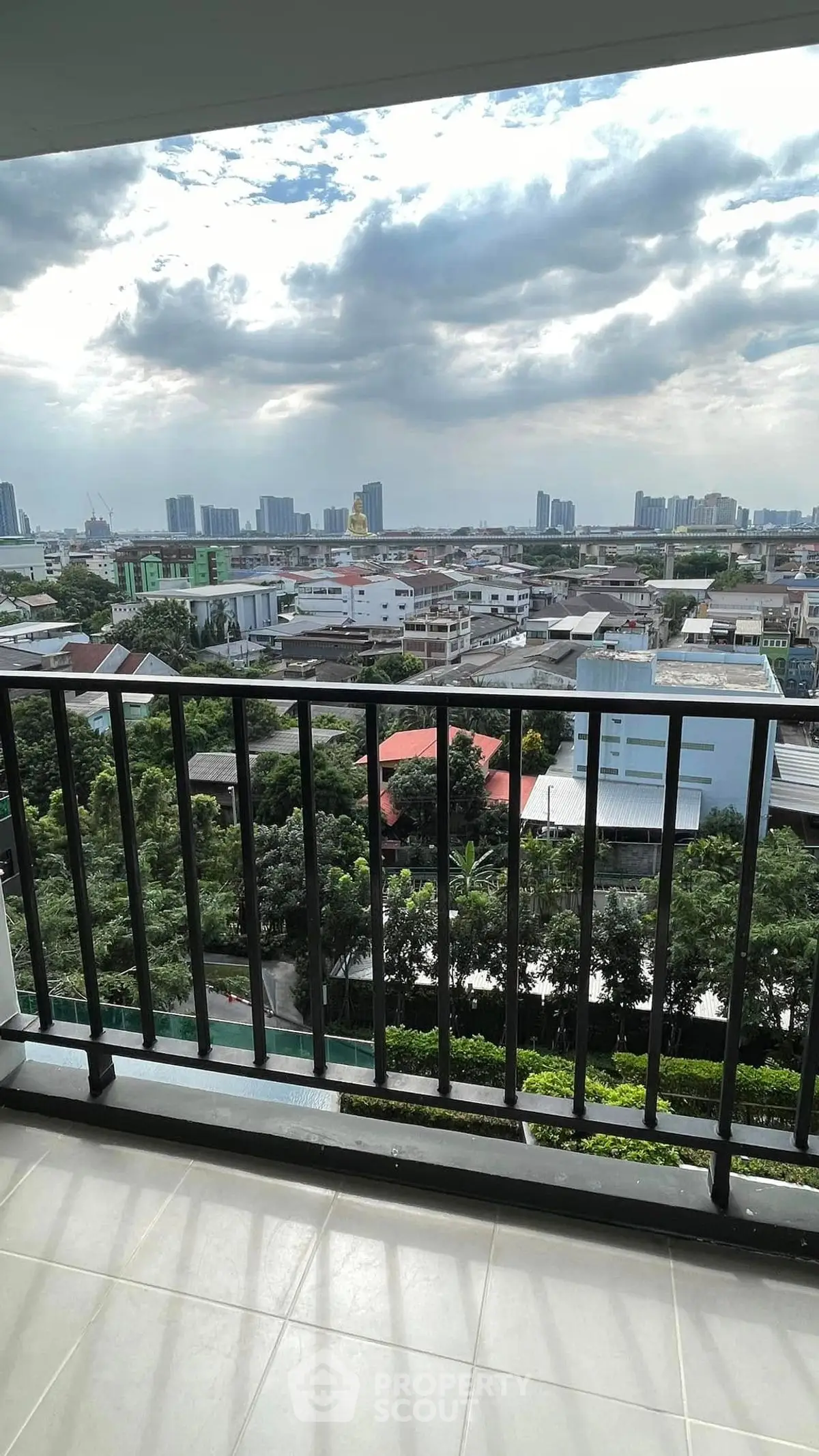 Stunning cityscape view from a spacious balcony in a modern apartment.