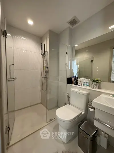 Modern bathroom with glass shower, sleek fixtures, and elegant design