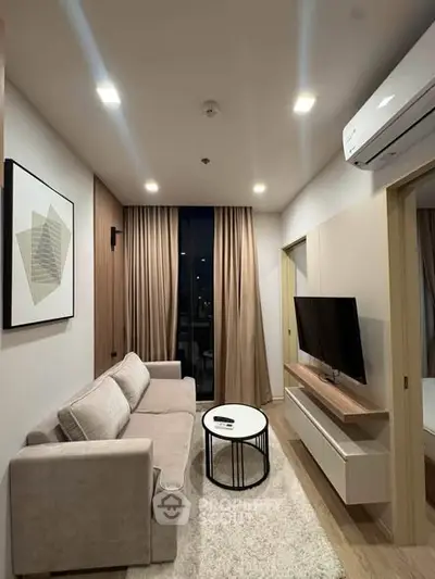 Modern living room with sleek furniture and wall-mounted TV, perfect for cozy evenings.