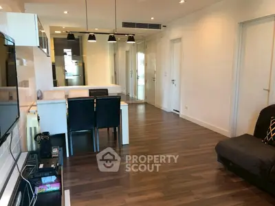Modern living room with sleek dining area and hardwood flooring