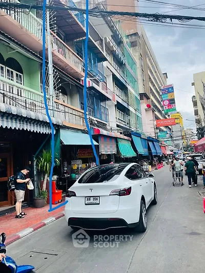 Vibrant street view with colorful buildings and bustling activity, showcasing urban lifestyle and local businesses.