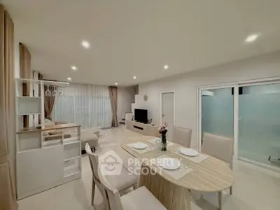 Spacious open-plan living and dining area with modern decor and ample natural light.