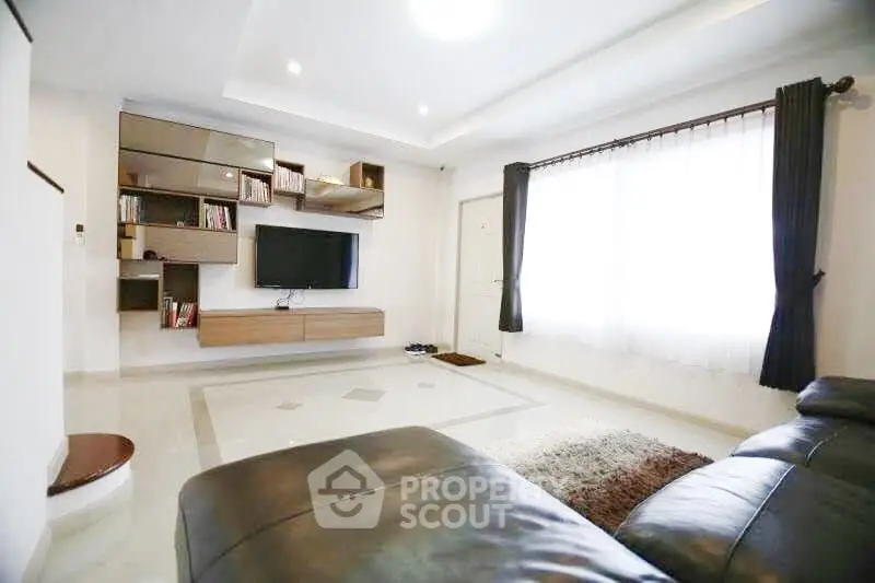 Spacious modern living room with sleek furniture and natural light