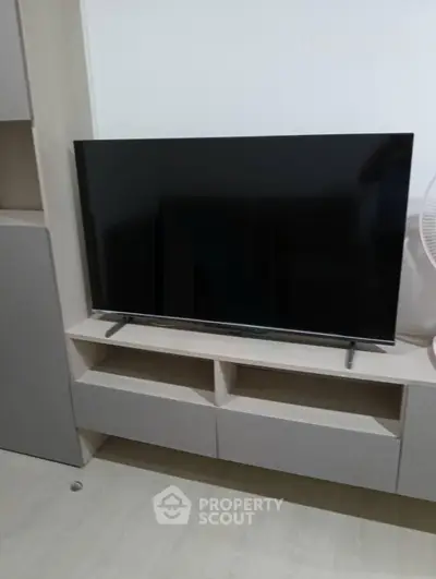 Modern living room with sleek TV on stylish wooden cabinet