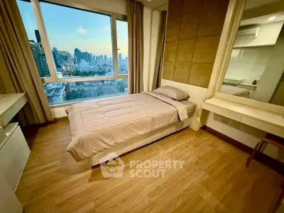 Modern bedroom with city view, featuring sleek design and large window for natural light.