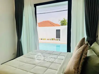 Luxurious bedroom with pool view and elegant curtains