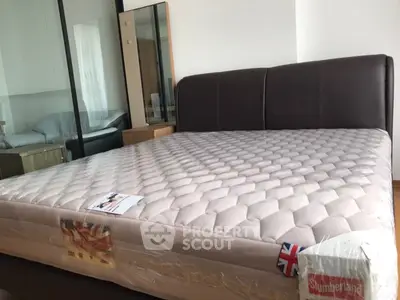 Spacious bedroom with a luxurious bed and modern glass partition, perfect for comfort and style.
