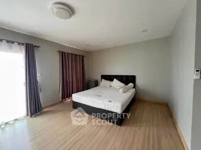 Spacious bedroom with natural light and modern decor