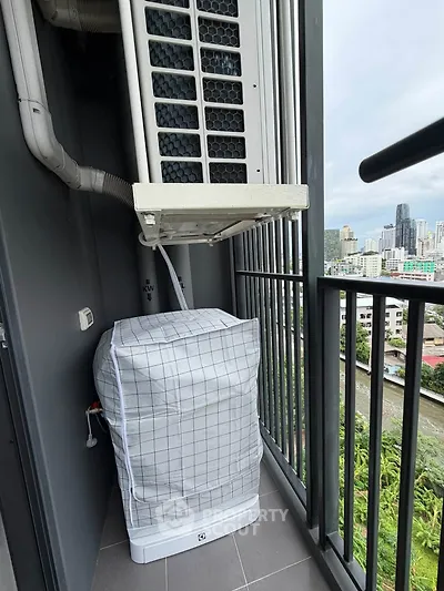 High-rise balcony with city view and air conditioning unit, perfect for urban living.
