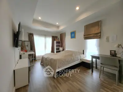 Spacious bedroom with modern decor and natural light