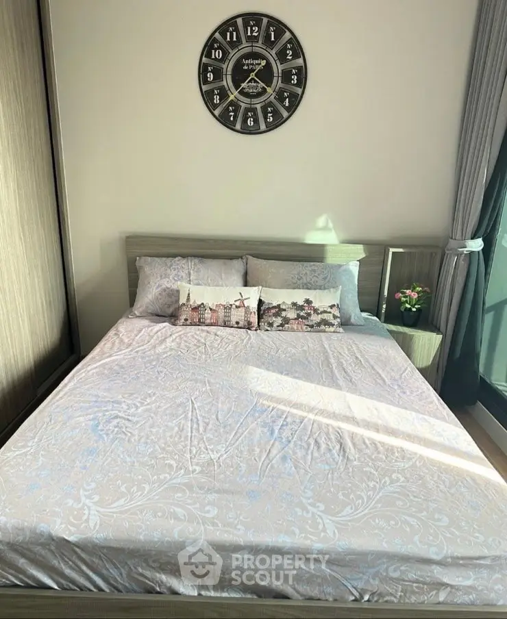 Cozy bedroom with stylish decor and large window for natural light