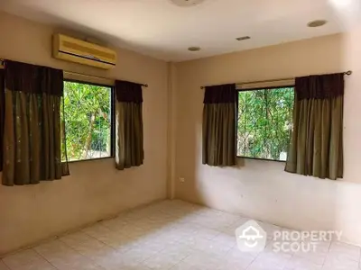 Spacious room with large windows and garden view, perfect for customization.