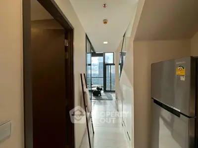 Modern apartment hallway leading to a stylish living room with a stunning view.