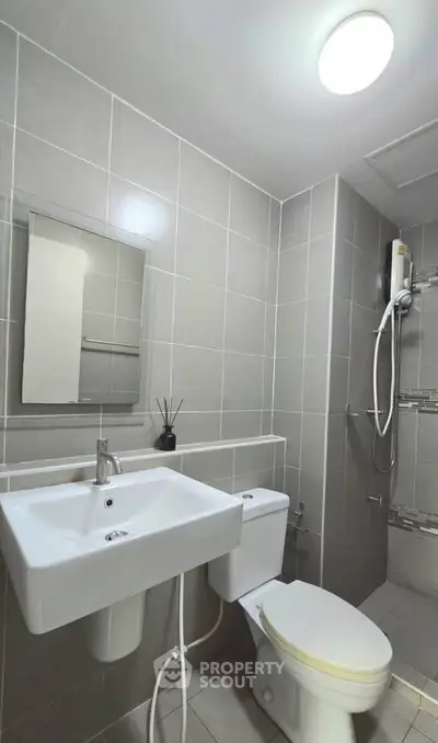 Modern bathroom with sleek fixtures and a walk-in shower in a contemporary apartment.
