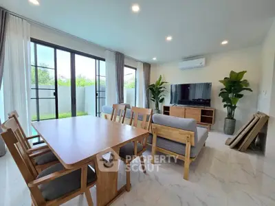 Spacious modern living room with large windows and stylish wooden furniture