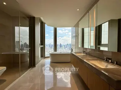Luxurious bathroom with stunning city view, featuring a freestanding bathtub and dual sinks.