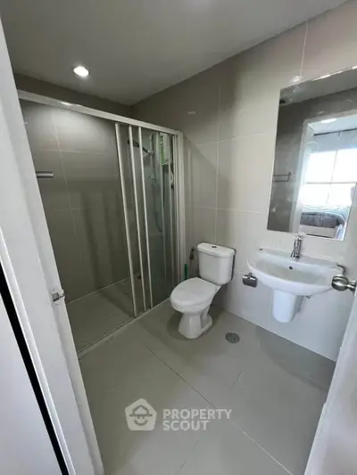 Modern bathroom with sleek shower and contemporary fixtures in a stylish apartment.