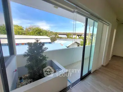 Spacious balcony with sliding glass doors and scenic view