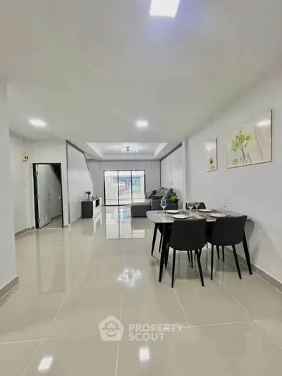 Spacious modern living room with sleek dining area and stylish decor, perfect for contemporary living.