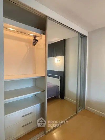 Spacious bedroom with built-in sliding door closet and modern design