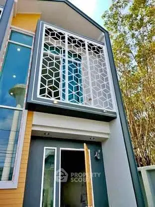 Modern townhouse exterior with unique geometric window design and open entrance