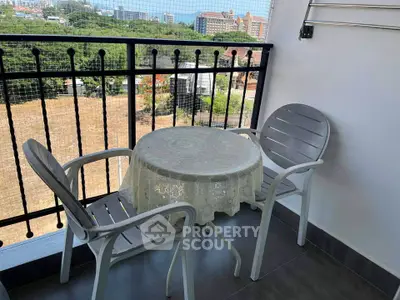 Charming balcony with cozy seating and scenic view, perfect for relaxation.