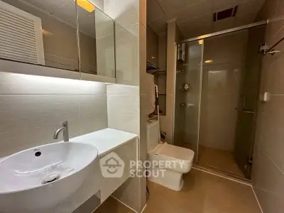 Modern bathroom with sleek fixtures and glass shower enclosure