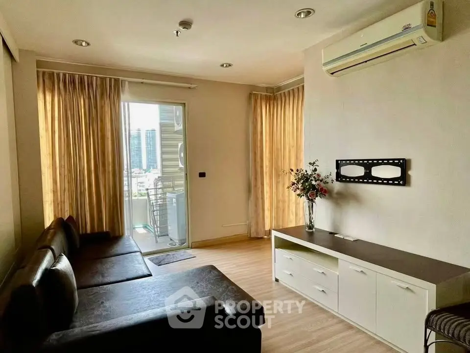 Spacious living room with modern decor and balcony view in a high-rise apartment.