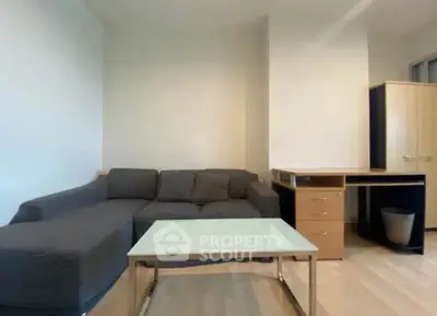 Modern living room with sleek furniture and minimalist design, featuring a cozy sofa and stylish desk.