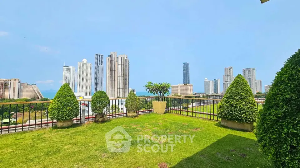 Stunning cityscape view from lush green rooftop garden in urban high-rise setting.