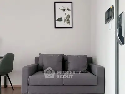Modern living room with cozy gray sofa and stylish wall art, perfect for relaxation.