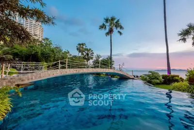 Luxurious poolside view with palm trees and ocean backdrop in a high-end real estate property.