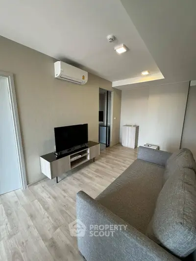 Modern living room with sleek furniture and air conditioning, perfect for comfortable living.