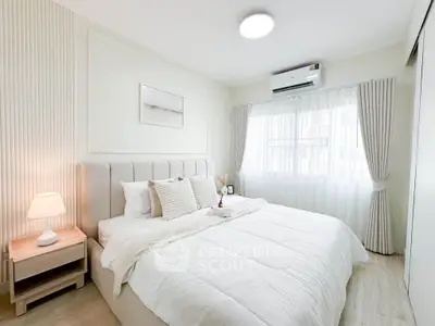 Elegant bedroom with cozy decor and natural light, featuring a plush bed and modern design.