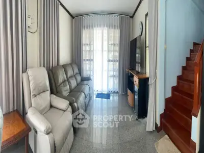Cozy living room with plush seating and natural light, perfect for relaxation.