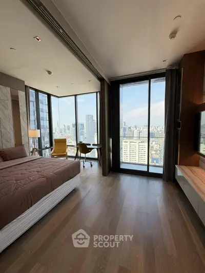 Luxurious bedroom with stunning city view and modern furnishings in high-rise apartment.
