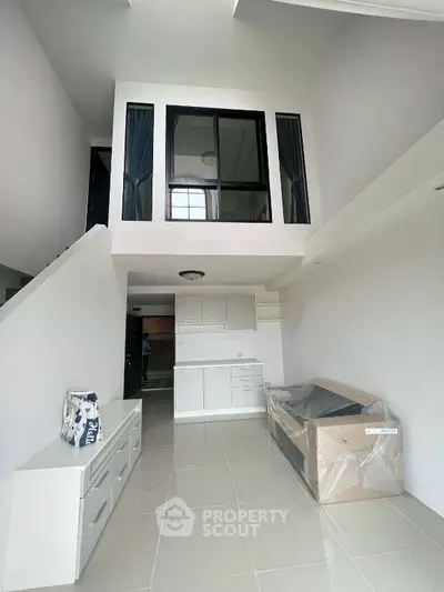 Modern loft apartment with high ceilings and sleek white interior design