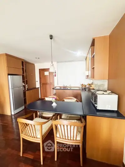 Charming kitchen with wooden cabinetry and modern appliances, perfect for culinary enthusiasts.