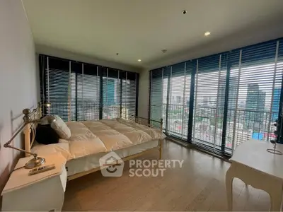 Spacious bedroom with panoramic city view and modern decor