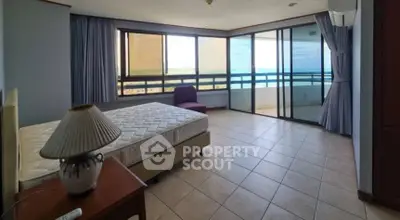 Spacious bedroom with ocean view and large balcony access.