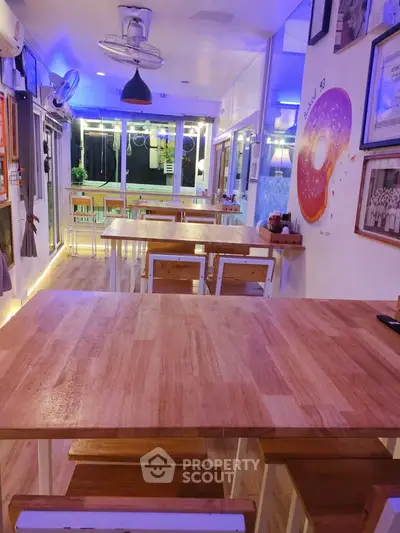 Charming dining area with wooden tables and ambient lighting, perfect for cozy gatherings.