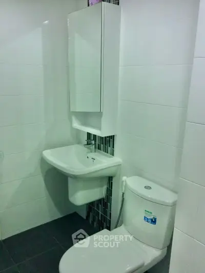 Modern bathroom with sleek white fixtures and stylish tile accents.
