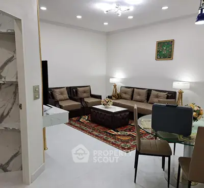 Elegant living room with modern furniture and stylish decor, featuring a cozy seating area and dining space.