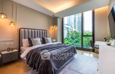Luxurious bedroom with modern decor and large window offering stunning city view.